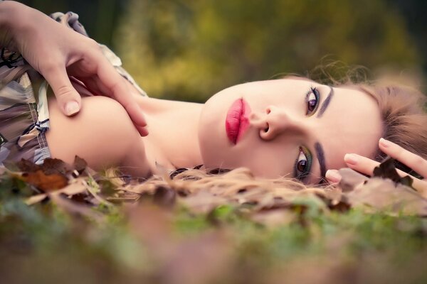 Chica con maquillaje en la naturaleza en otoño
