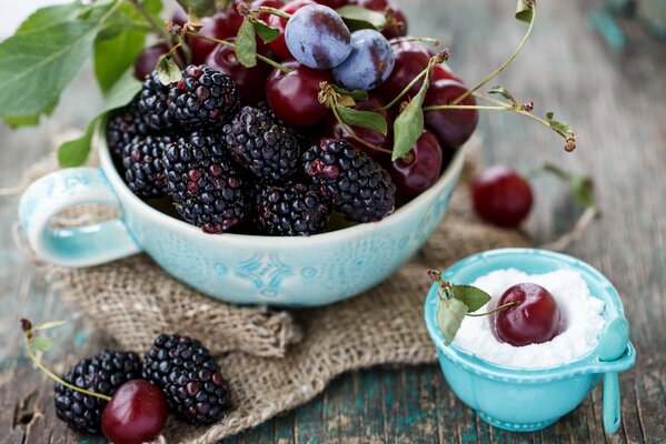 Ciruela de mora y cereza en un plato azul