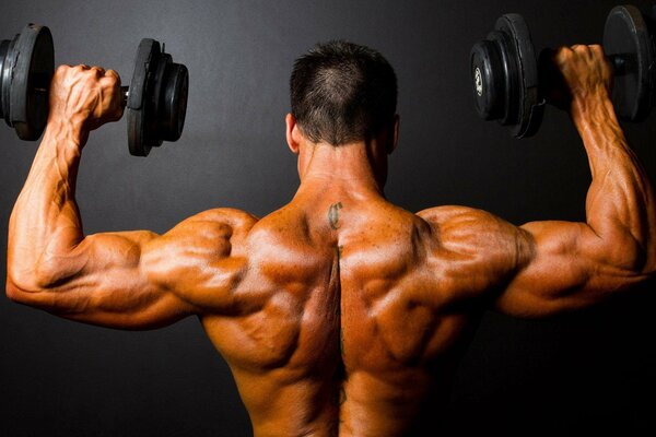 Musculoso duro atleta hace ejercicios de brazo