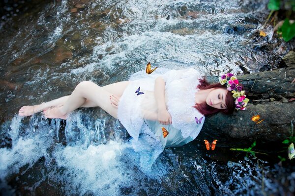 Chica con mariposas en el río